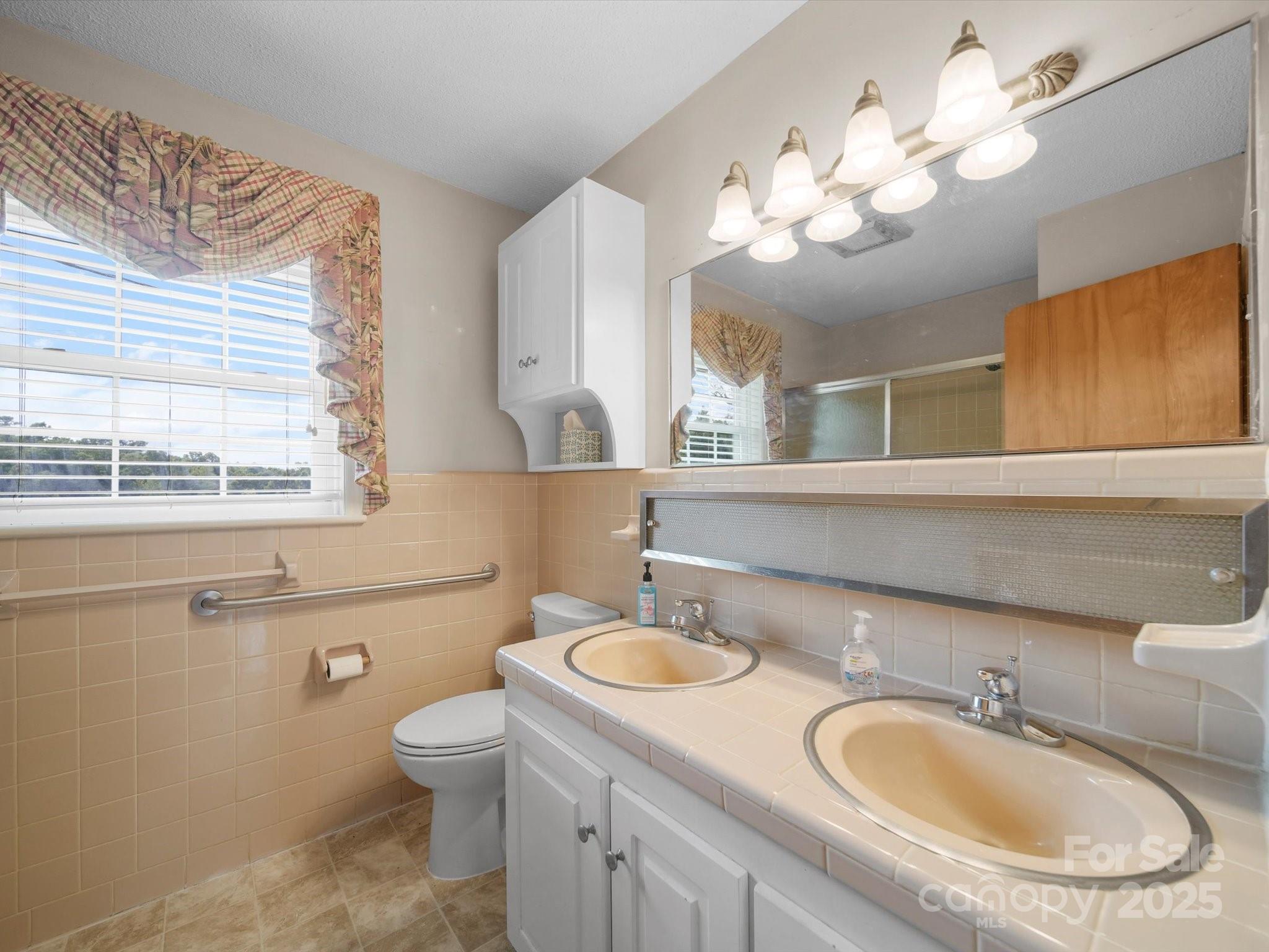 1497 White Store Road Pageland, SC 29728 - Photo 21 of 43 a bathroom with a toilet a sink and mirror