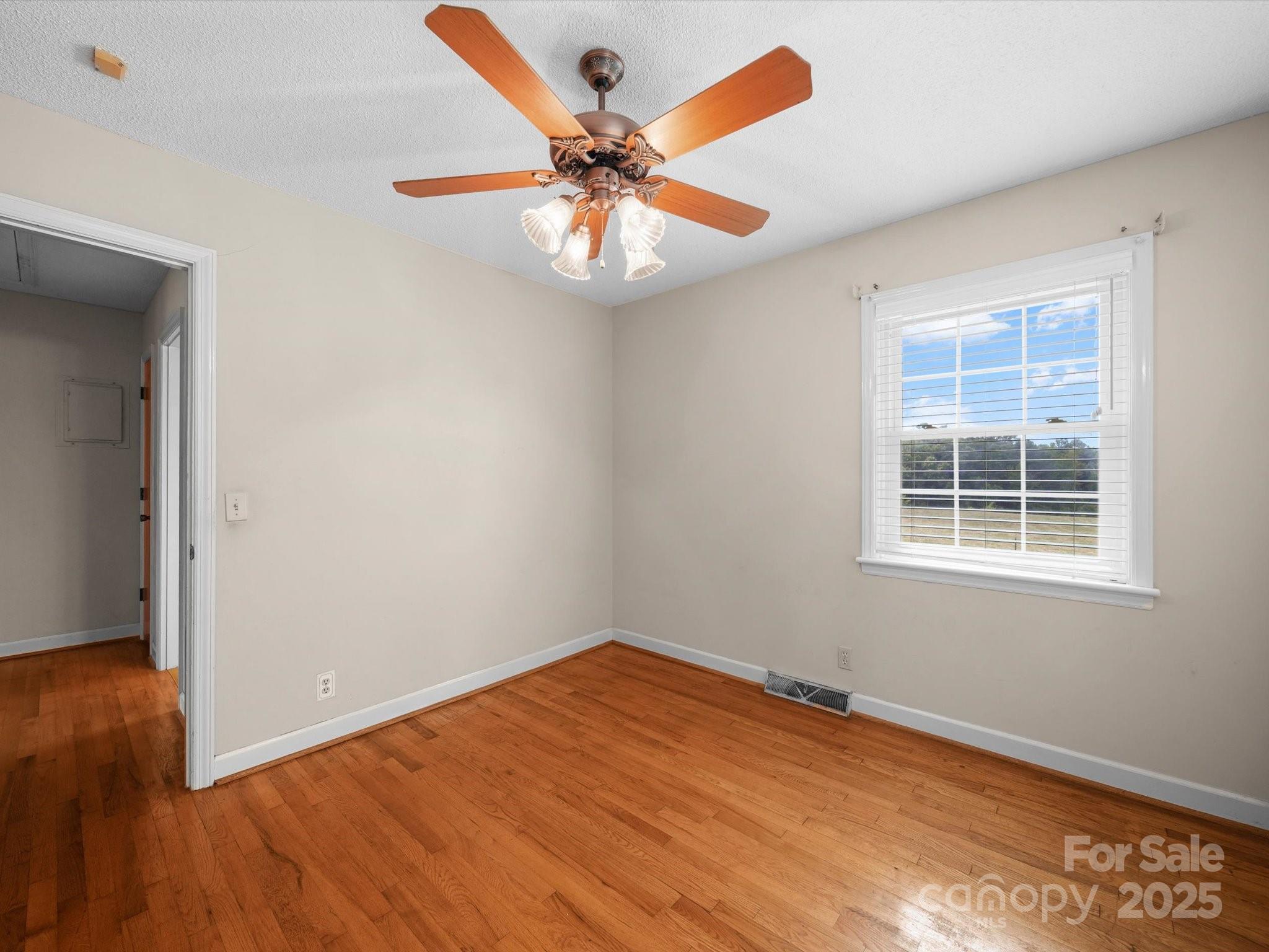 1497 White Store Road Pageland, SC 29728 - Photo 24 of 43 an empty room with wooden floor closet and windows