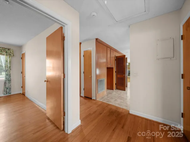 a view of hallway with wooden floor