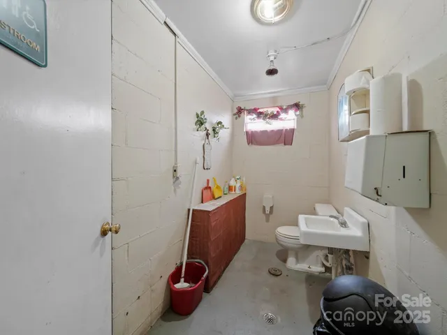 a bathroom with a sink mirror and toilet