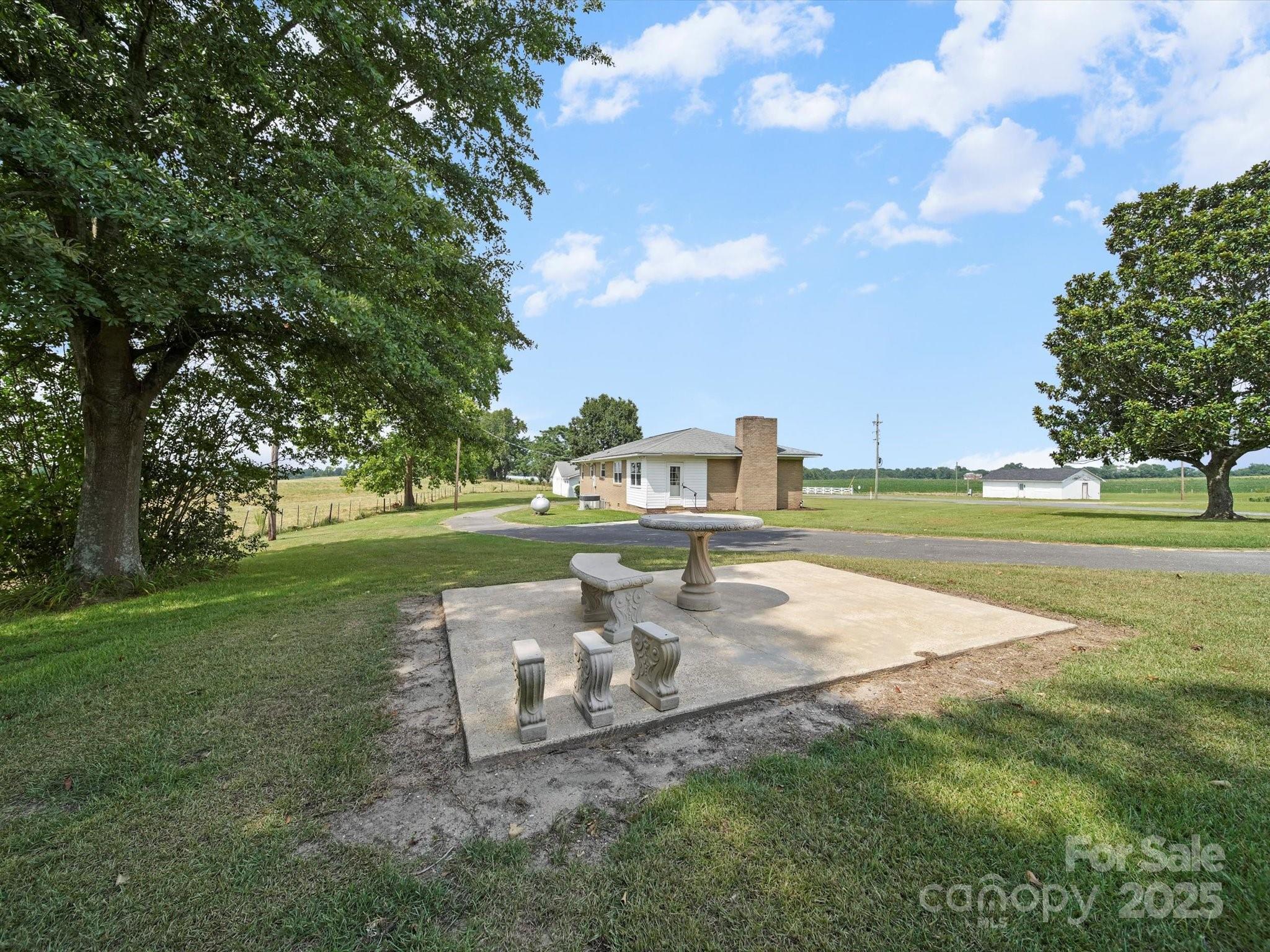 1497 White Store Road Pageland, SC 29728 - Photo 7 of 43 a view of a fountain in front of a house with a big yard