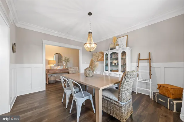 a view of a kitchen with dining space wooden floor electric appliances and windows