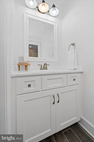 a bedroom with a bed a window and potted plant on a dresser