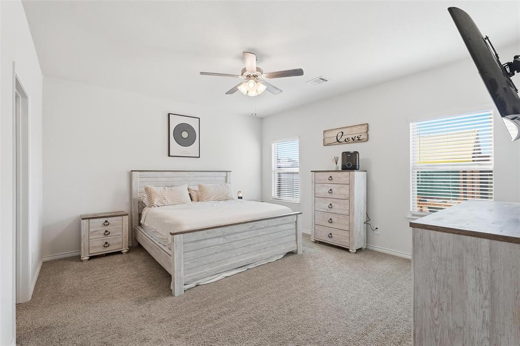 103 Lantern Road Caddo Mills, TX 75135 - Photo 18 of 33 a spacious bedroom with a bed and a window