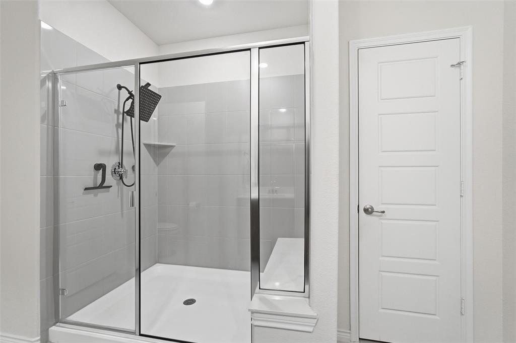 103 Lantern Road Caddo Mills, TX 75135 - Photo 21 of 33 a bathroom with a glass shower door