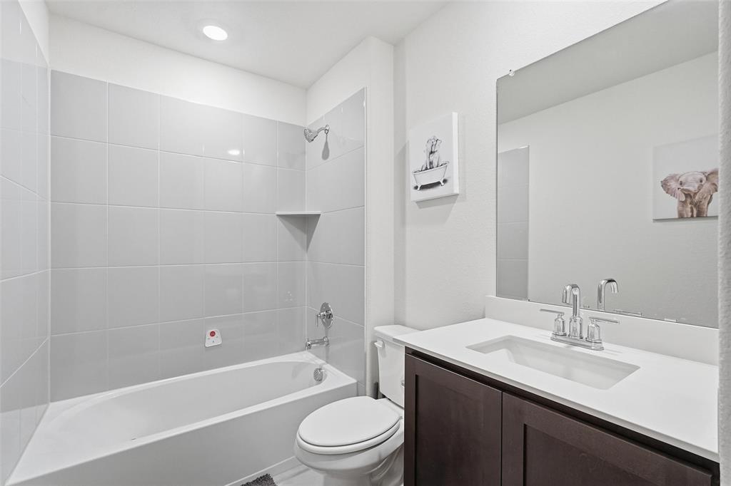 103 Lantern Road Caddo Mills, TX 75135 - Photo 26 of 33 a bathroom with a granite countertop sink toilet and shower