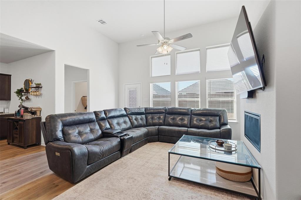 103 Lantern Road Caddo Mills, TX 75135 - Photo 6 of 33 a living room with furniture a fireplace and a large window