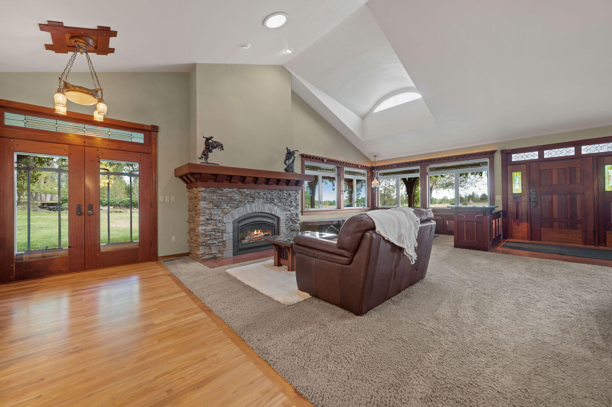21925 Bear Creek Road Bend, OR 97702 - Photo 14 of 104 Side entry into Great Room with fireplace, wrap-around windows, eyebrow windows and Front Door