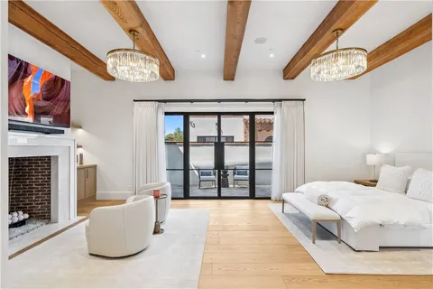 a view of a hallway with wooden floor and a fireplace