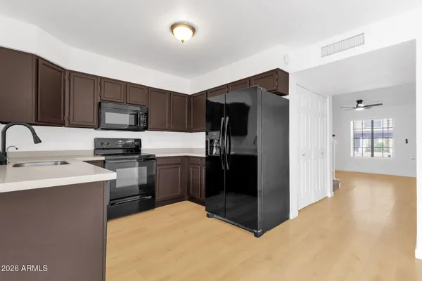 a kitchen with stainless steel appliances granite countertop a stove microwave and sink
