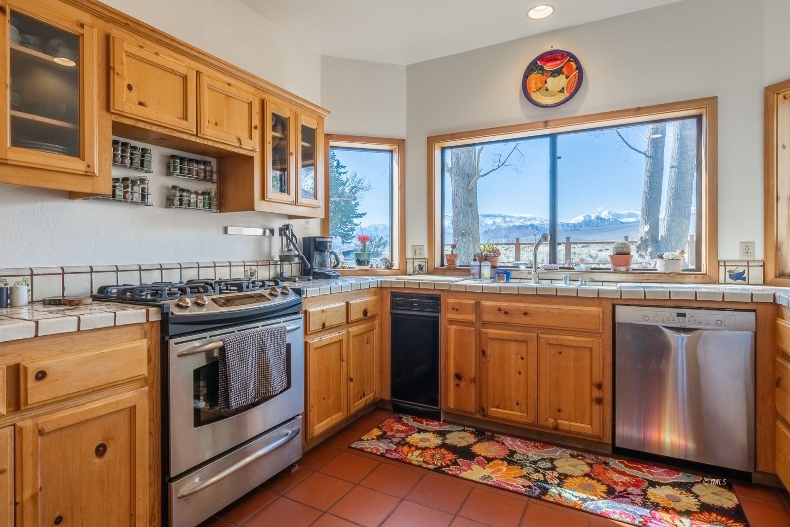 150 Hardy Road Bishop, CA 93514 - Photo 19 of 35 a kitchen with stainless steel appliances granite countertop a stove a sink dishwasher and cabinets with wooden floor