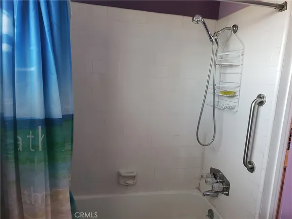 a bathroom with a shower and a shower