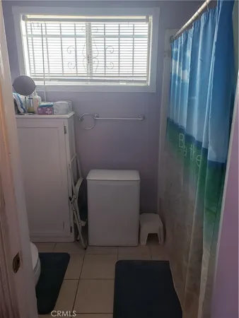 a bathroom with sink toilet and window