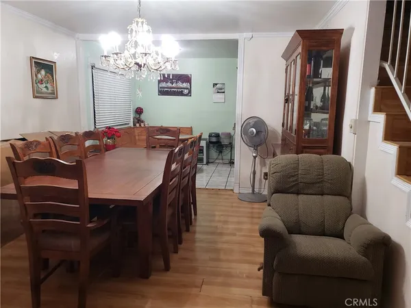 a view of a dining room with furniture and chandelier