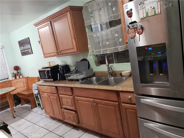 a kitchen with stainless steel appliances granite countertop a sink dishwasher and cabinets with wooden floor