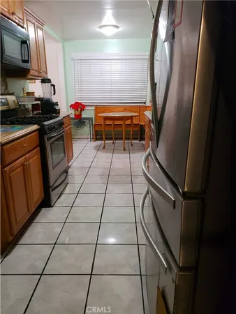a kitchen with stainless steel appliances granite countertop a sink a stove top oven a counter space and cabinets