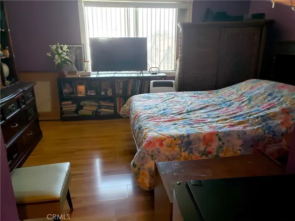 a bedroom with a bed window and table