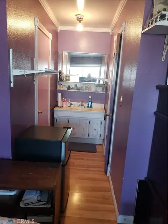 a kitchen with stainless steel appliances a refrigerator and wooden floor