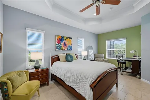 a bedroom with a bed couch and window