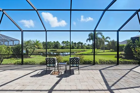 a view of a park with couches chairs with wooden floor