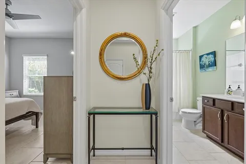 a bathroom with a toilet a sink and a mirror