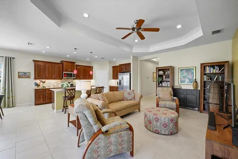 a living room with furniture and kitchen view
