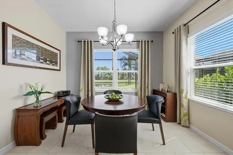 a dining room with furniture and window