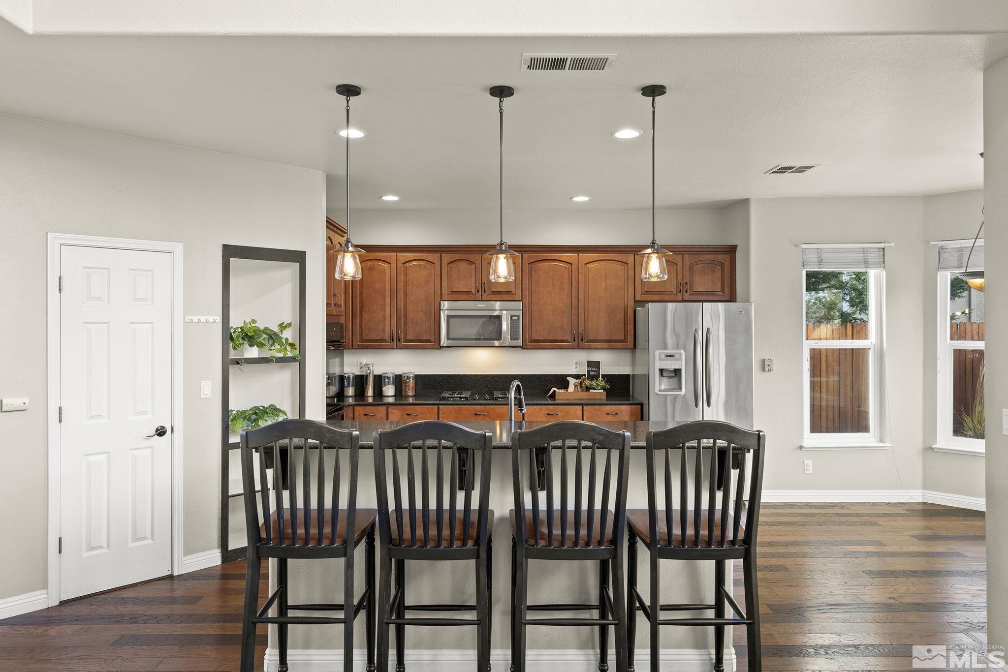 9965 Bandana Way Reno, NV 89521 - Photo 14 of 40 a view of a dining room with furniture and wooden floor