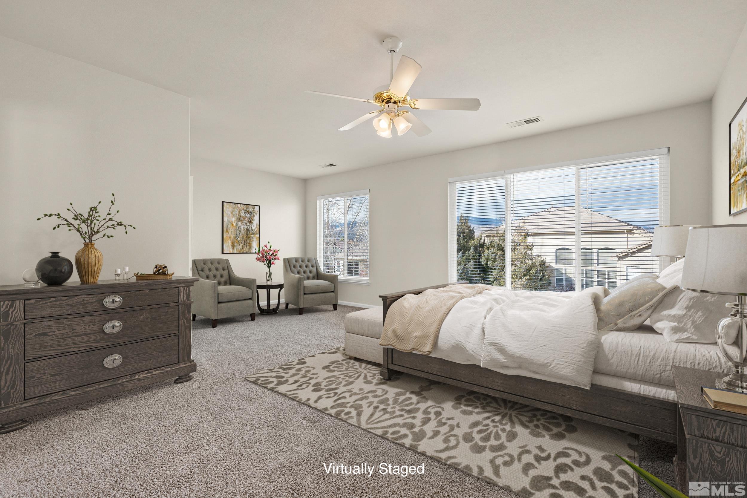 9965 Bandana Way Reno, NV 89521 - Photo 17 of 40 a bedroom with a bed couches chair and a large window