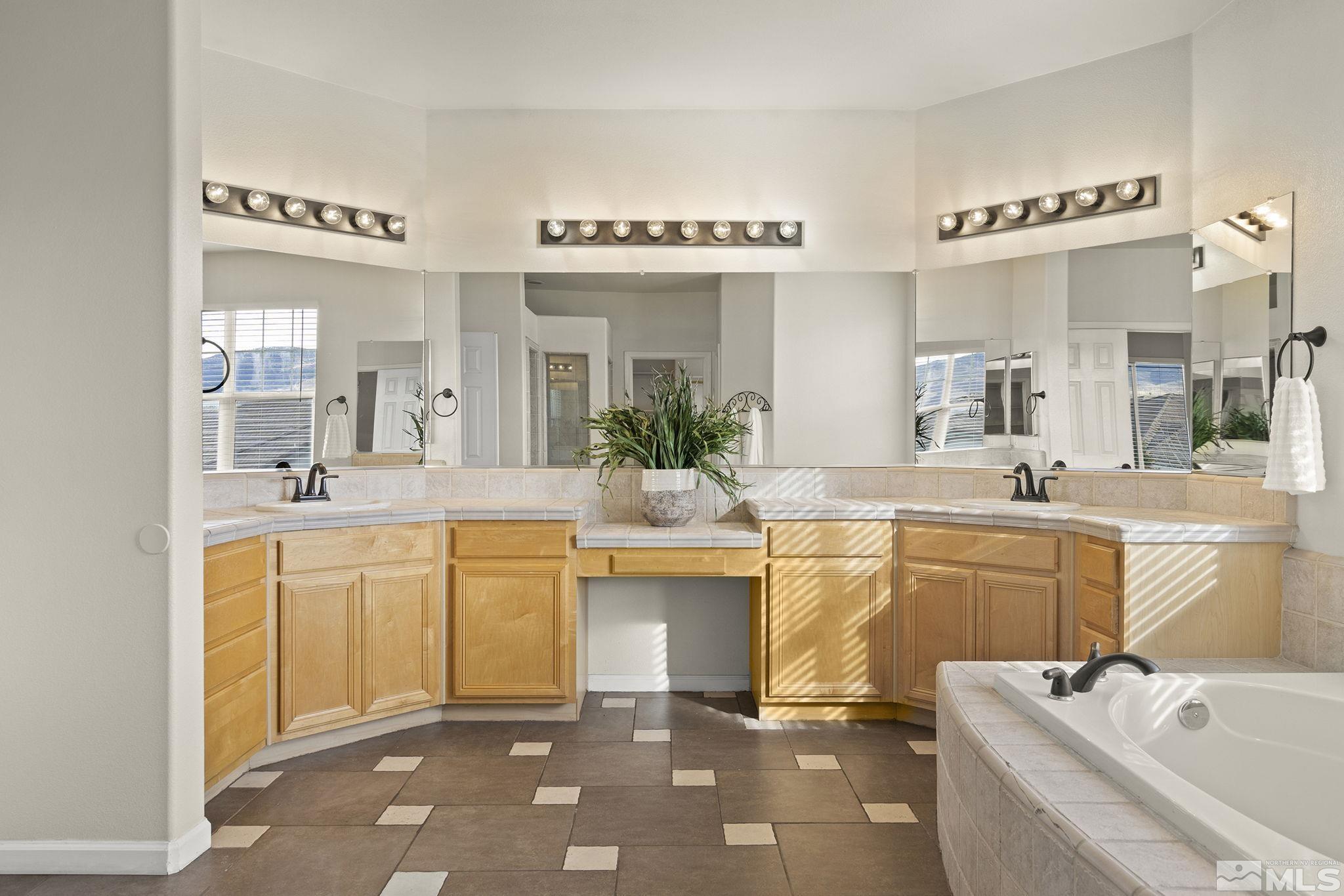 9965 Bandana Way Reno, NV 89521 - Photo 19 of 40 a spacious bathroom with a granite countertop sink mirror and bathtub