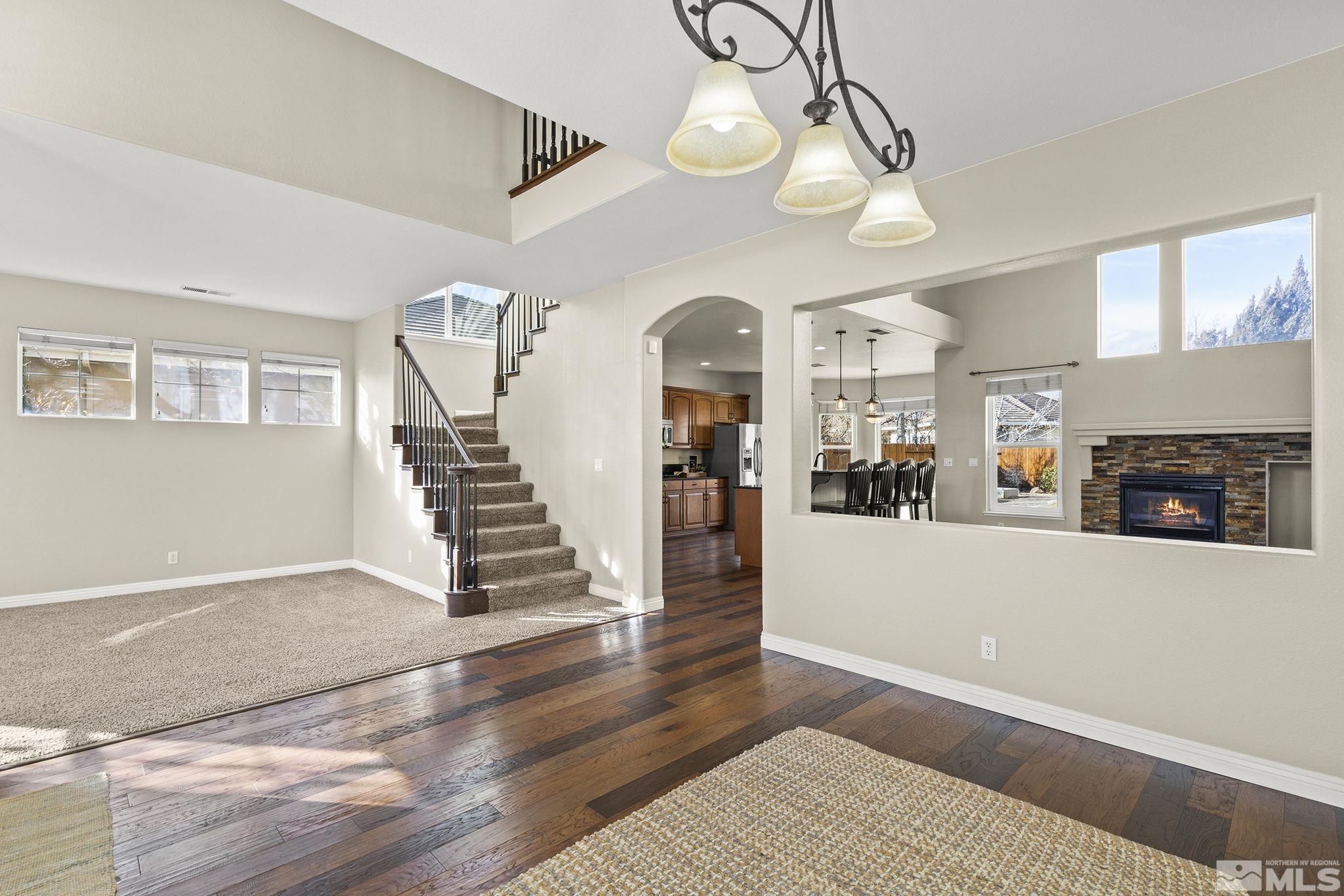 9965 Bandana Way Reno, NV 89521 - Photo 22 of 40 a view of a livingroom with wooden floor and a ceiling fan