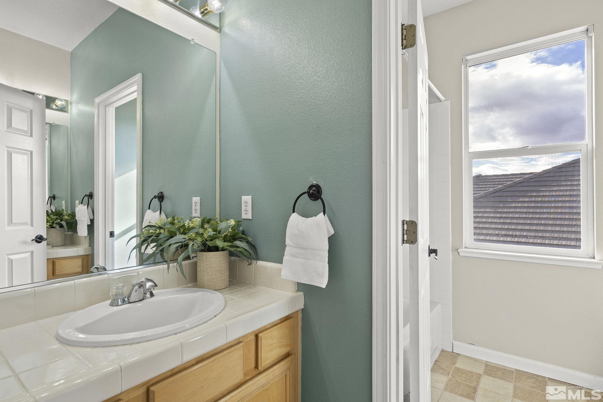 9965 Bandana Way Reno, NV 89521 - Photo 28 of 40 a bathroom with a sink and a mirror