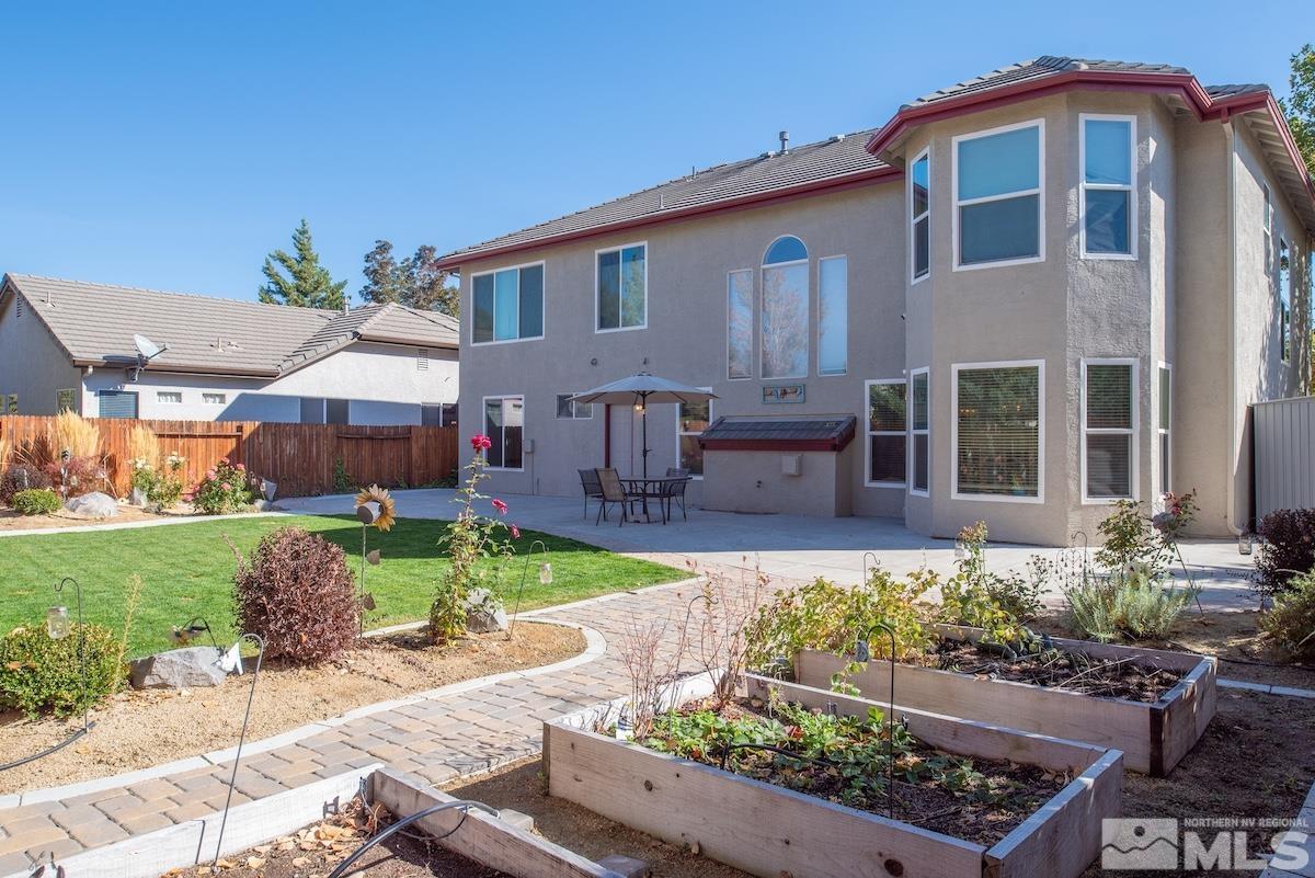 9965 Bandana Way Reno, NV 89521 - Photo 34 of 40 a front view of a house with a yard and a garden