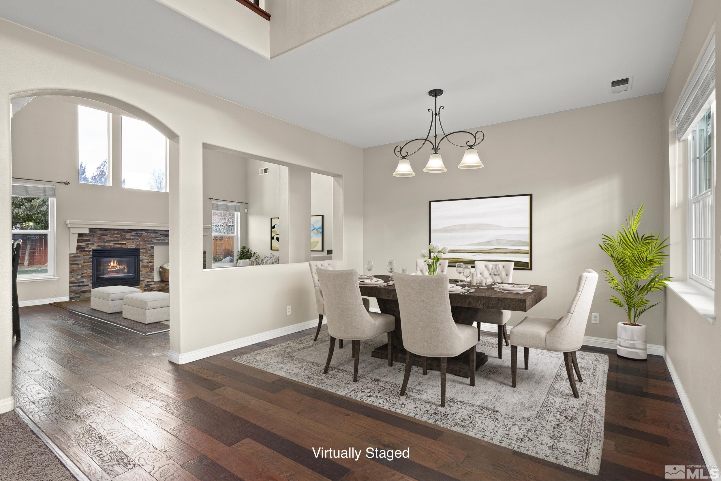 9965 Bandana Way Reno, NV 89521 - Photo 5 of 40 a dining room with furniture a chandelier and wooden floor