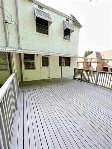 a view of a house with wooden deck