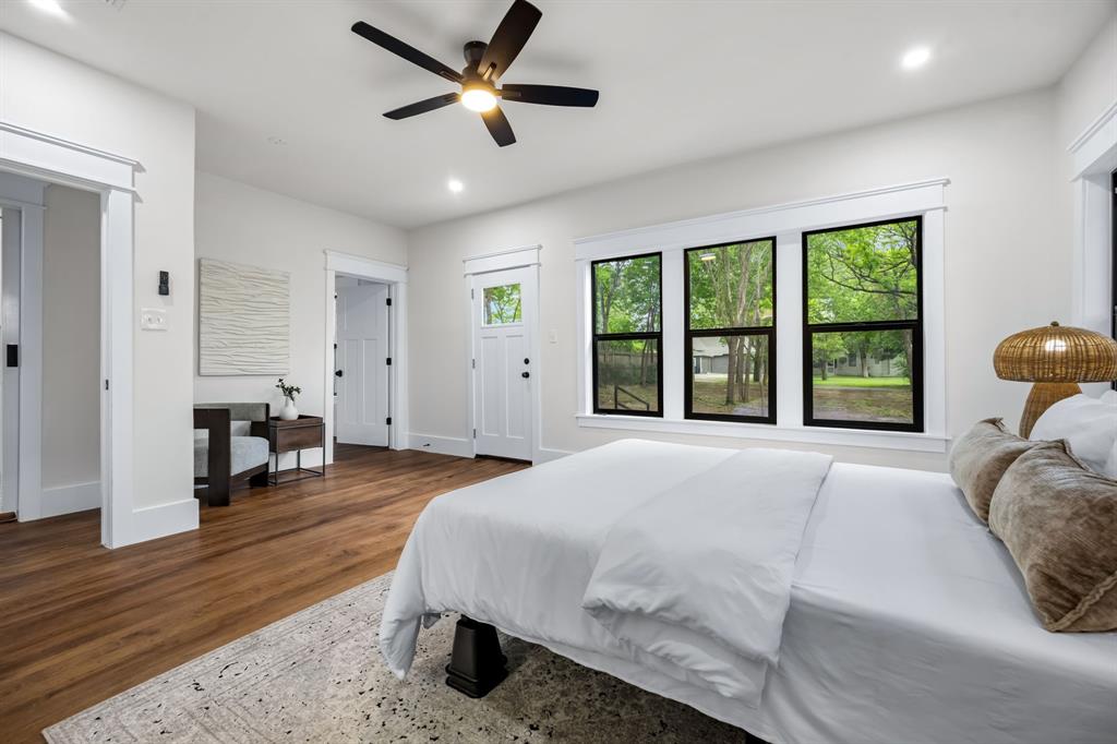 1014 Bolivar Street Denton, TX 76201 - Photo 20 of 36 a spacious bedroom with a large bed and a large window