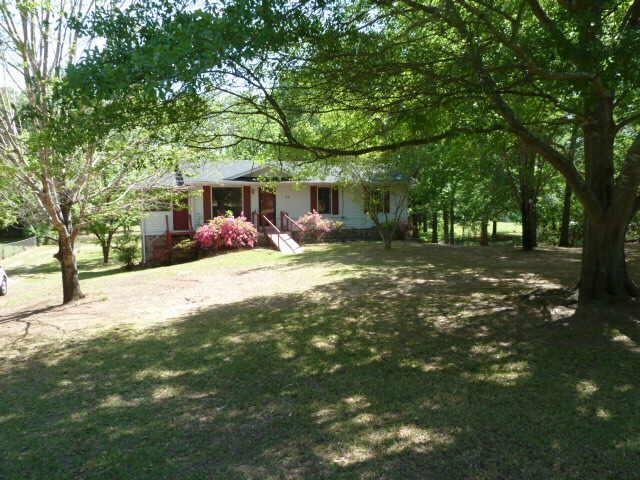 31 Woodland Road Griffin, GA 30224 - Photo 1 of 1 a view of a backyard with table and chairs and a large tree