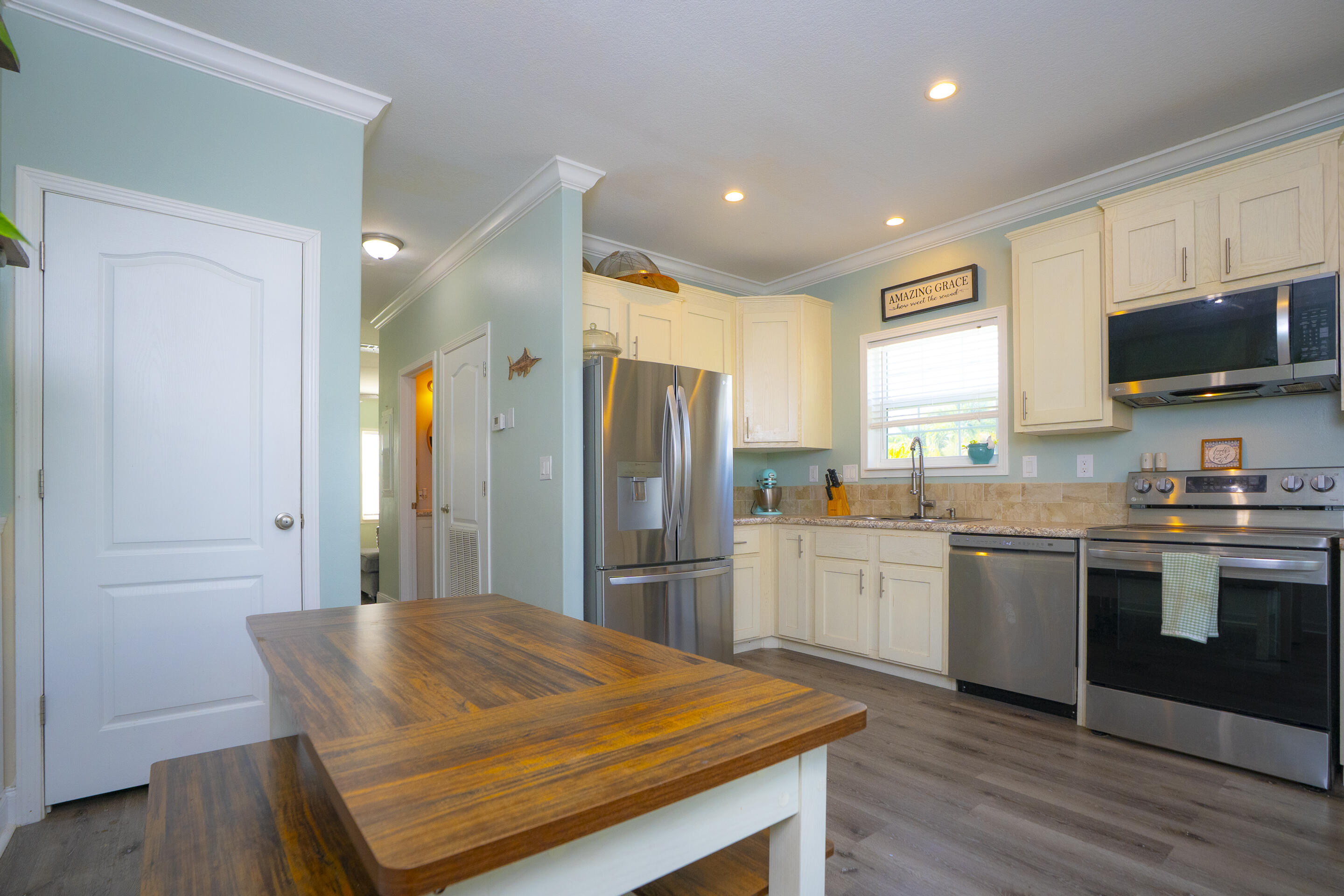 55 Ed Swift Road Key West, FL 33040 - Photo 7 of 23 a kitchen with stainless steel appliances granite countertop a refrigerator and a stove top oven