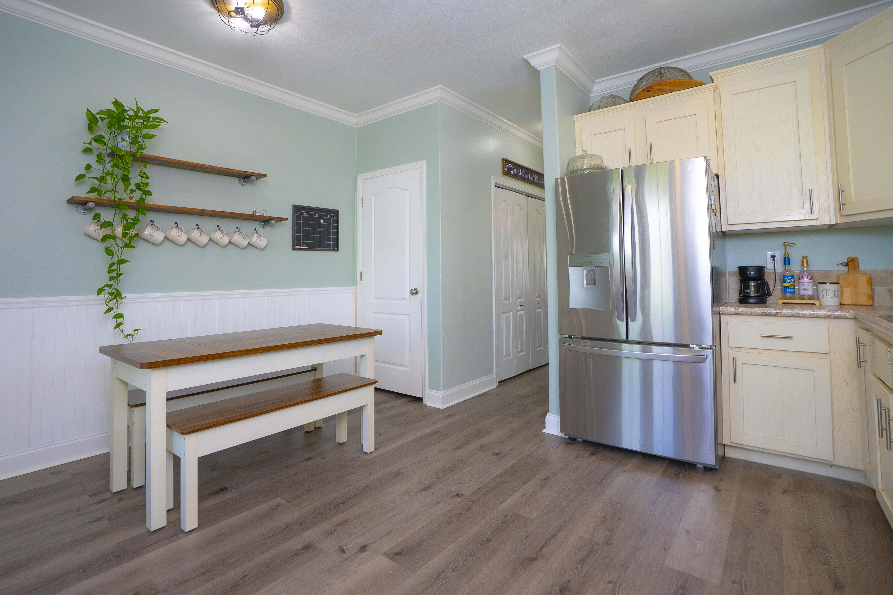 55 Ed Swift Road Key West, FL 33040 - Photo 8 of 23 a kitchen with refrigerator and wooden floor