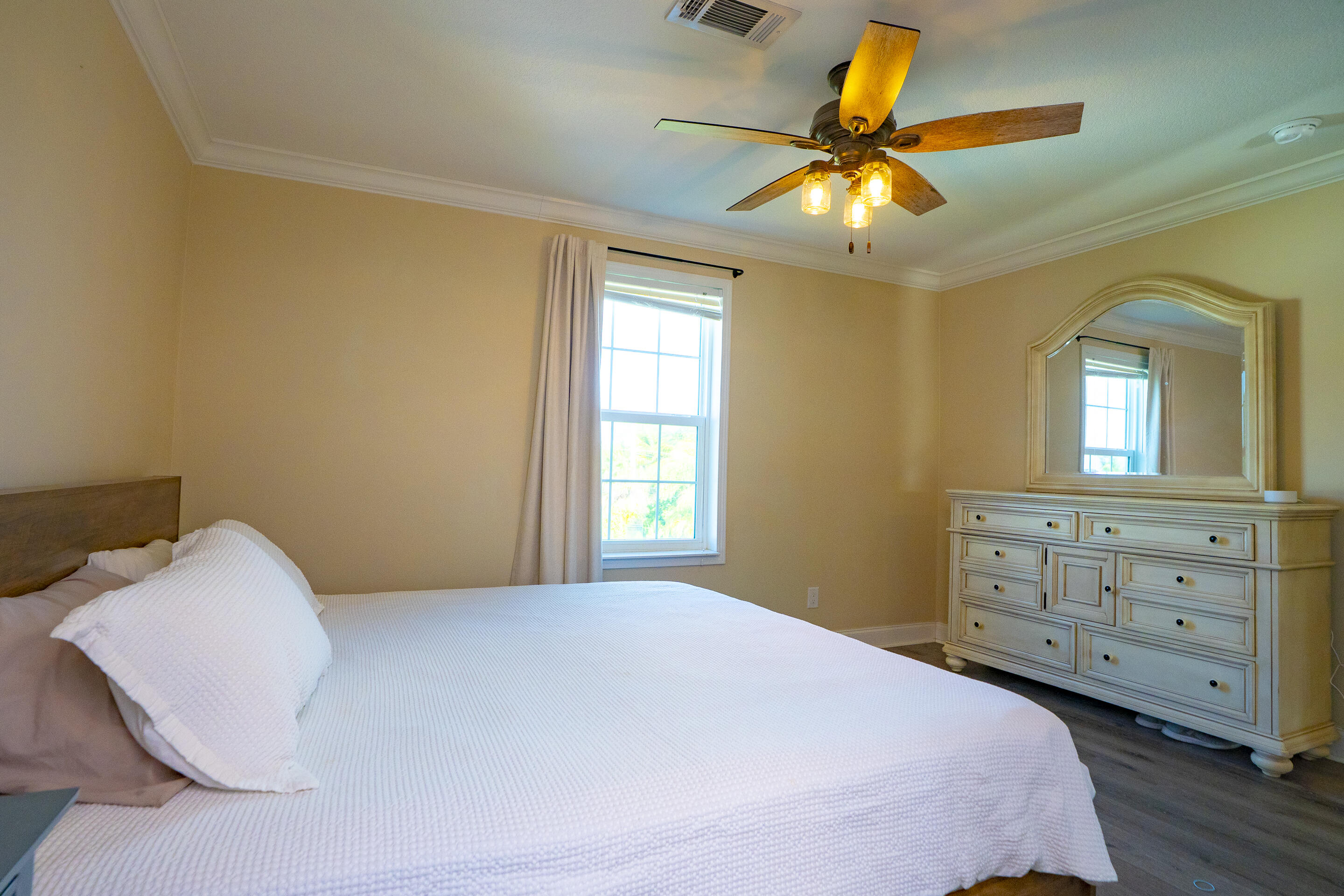 55 Ed Swift Road Key West, FL 33040 - Photo 10 of 23 a bedroom with a bed and a chandelier