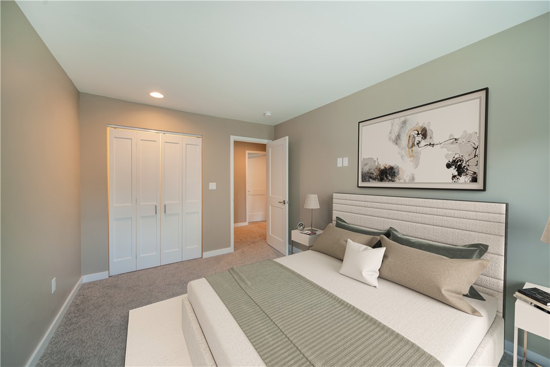 One of (4) bedrooms. Image is virtually staged. New drywall, lighting, doors, carpet, electrical outlet covers.