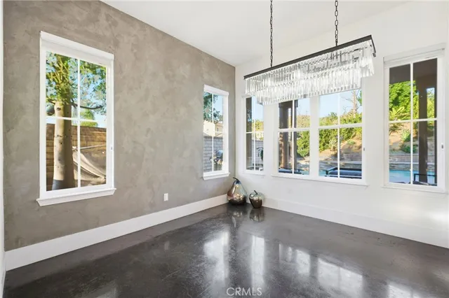 a large kitchen with kitchen island a large counter top space a sink stainless steel appliances and cabinets
