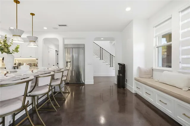 a living room with furniture a flat screen tv and a large window