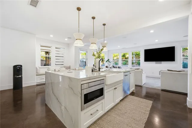 a living room with a fireplace and cabinets