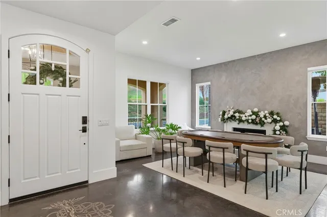 a dining room with furniture and window