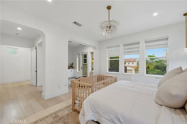 a spacious bedroom with a bed and a large window