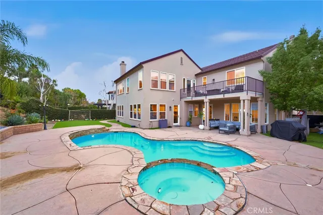 a view of a house with swimming pool and sitting area