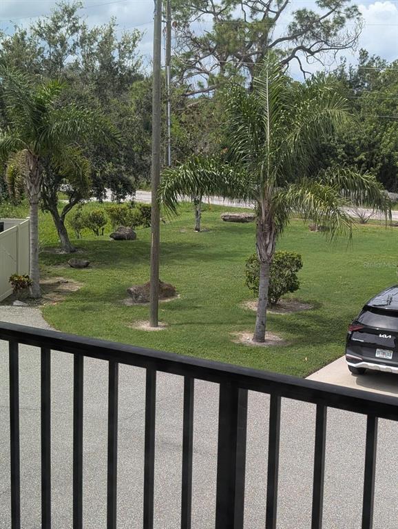 6394 Banyan Boulevard, Unit 204 New Port Richey, FL 34652 - Photo 16 of 25 a view of a wooden deck and a lake