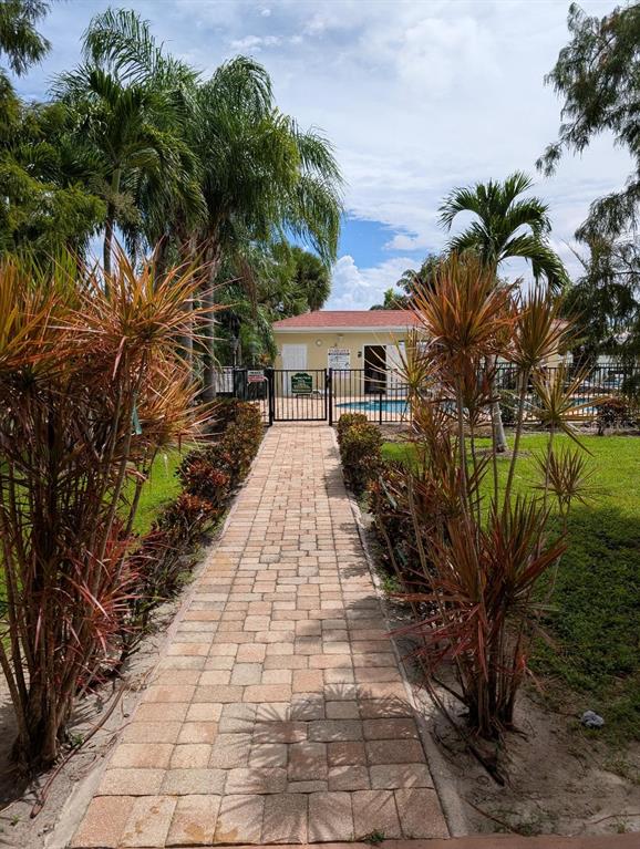 6394 Banyan Boulevard, Unit 204 New Port Richey, FL 34652 - Photo 18 of 25 a view of a pathway with a yard