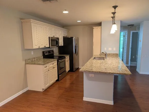 a kitchen with a sink microwave and refrigerator